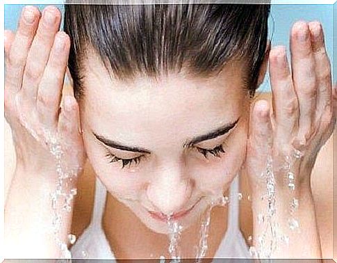 Woman washing her face