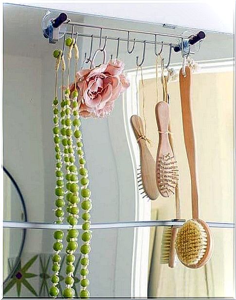 Stick adhesive hangers on the bathroom mirror