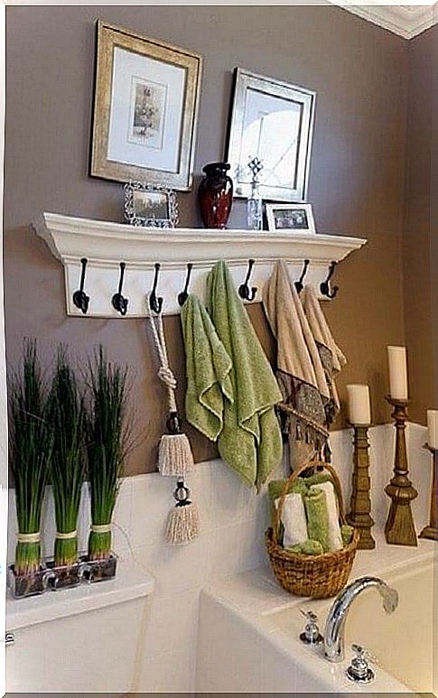 A hanger with a shelf helps you gain space in the bathroom