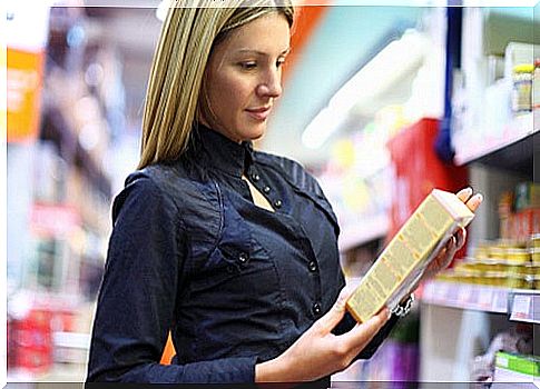 Woman looking at a box of cereal