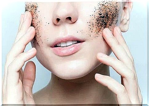 Woman exfoliating her face with coffee grounds