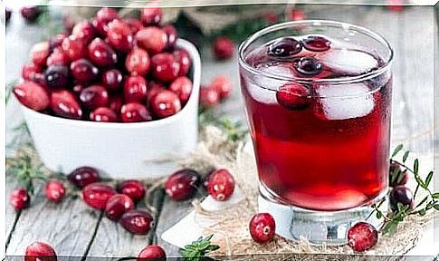 Cranberry bowl next to a glass of juice