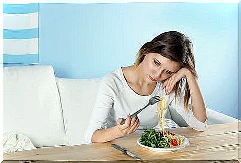 Woman showing hidden symptoms of depression at the table